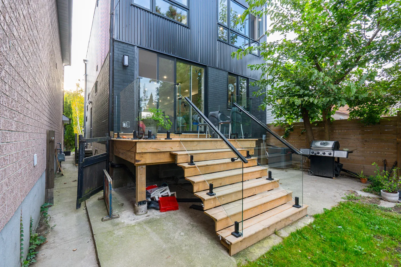 The deck and stairs seen along the side yard approach, Ajax