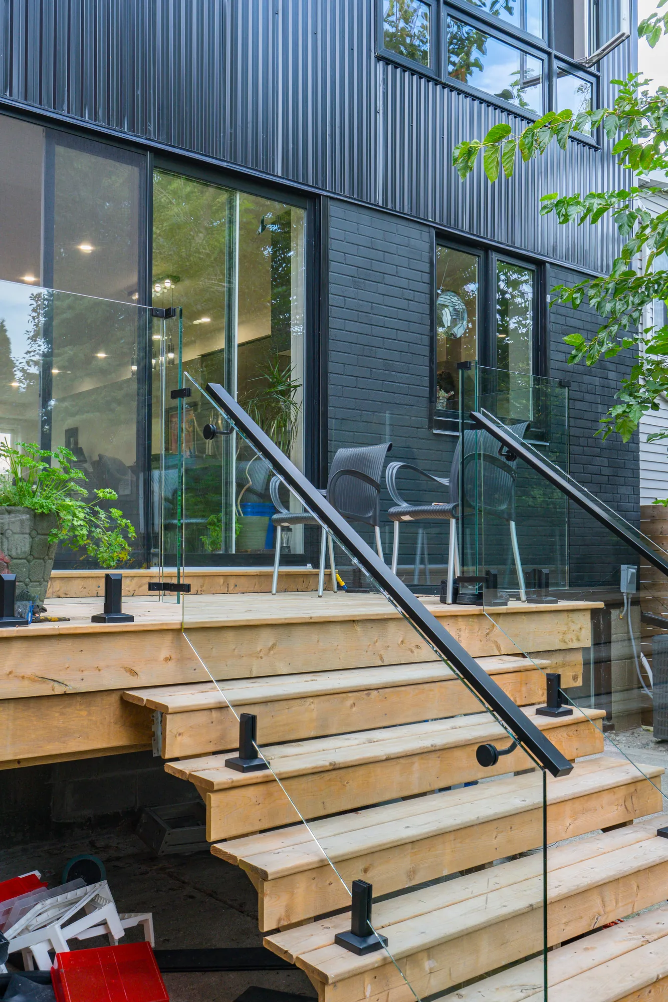 Wide stair treads and glass panels running down to grade, Ajax