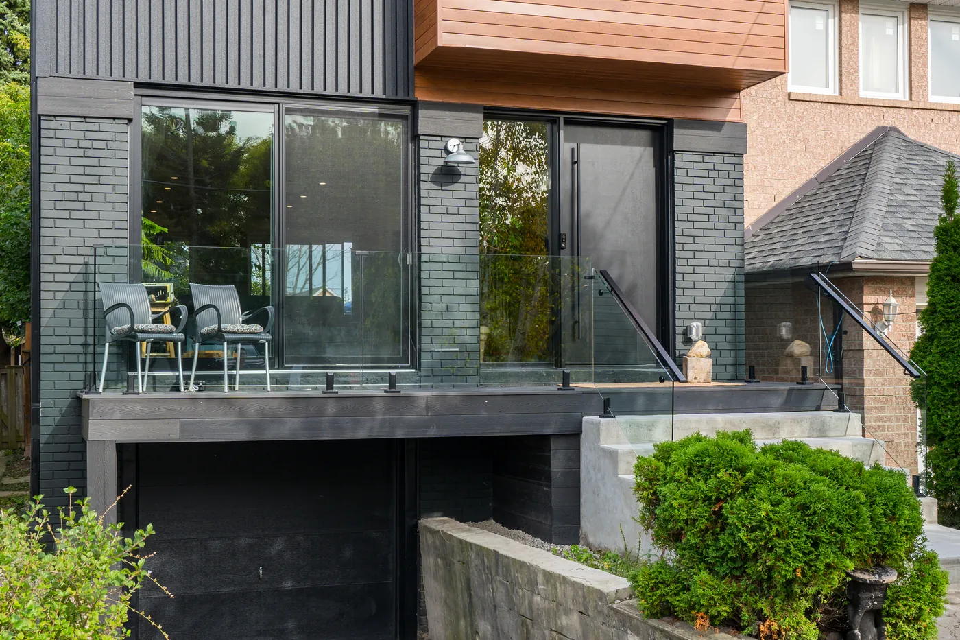 Glass railing on the raised terrace over the garage at the front of the Ajax home
