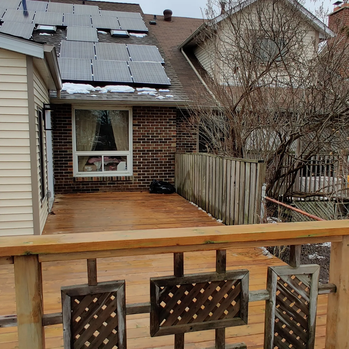 Lattice panels set into the pressure-treated railing frame, Brampton