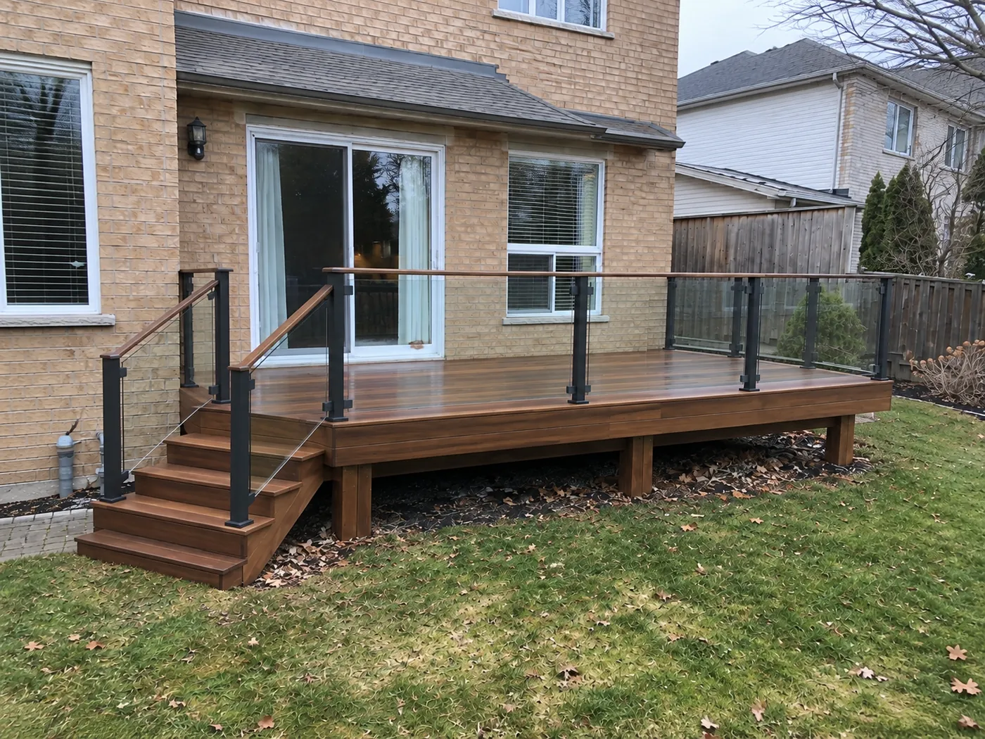 Ipe deck with glass railing in black aluminum posts and an ipe top rail in Burlington