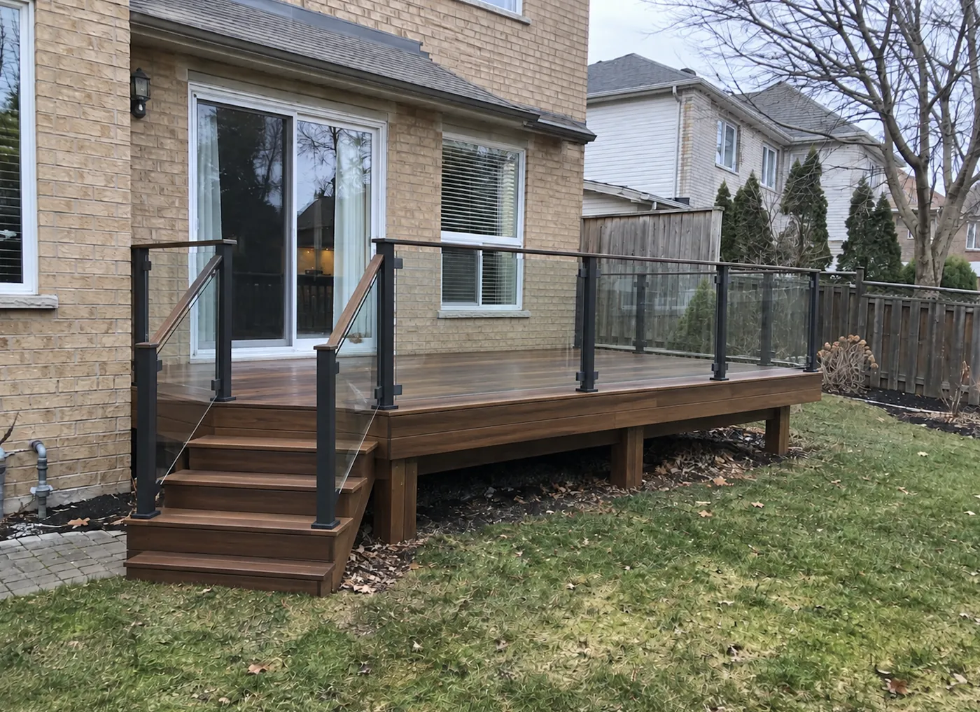 Ipe stairs and glass railing running down to the paver walk in Burlington