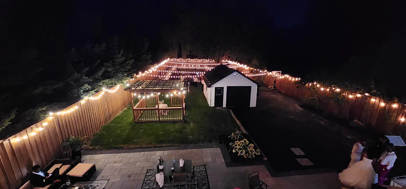 String lights strung off the new fence over the patio at night, Clarington