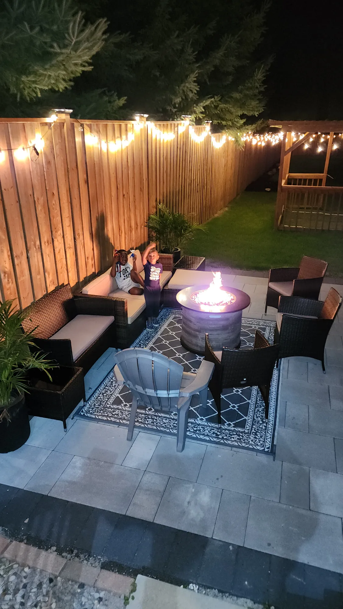 Fire pit seating against the new privacy fence in the evening, Clarington