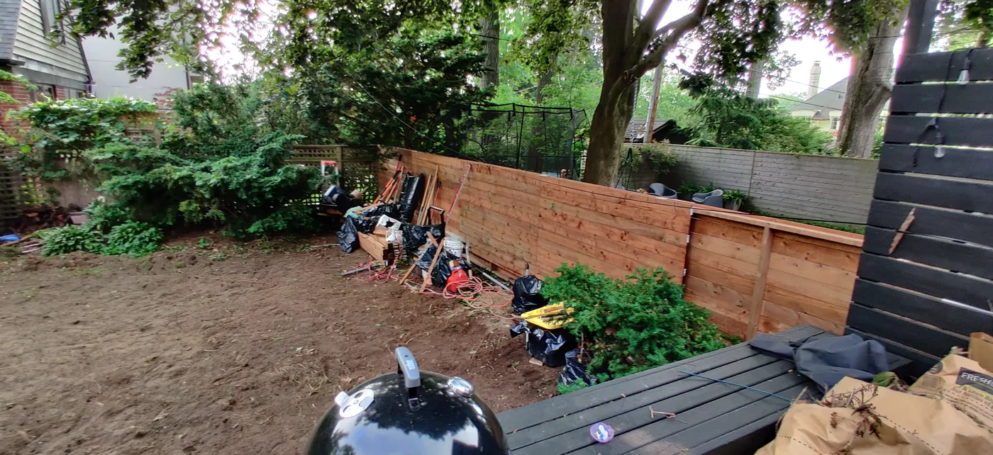Horizontal fence boards going up along the rear property line in East York