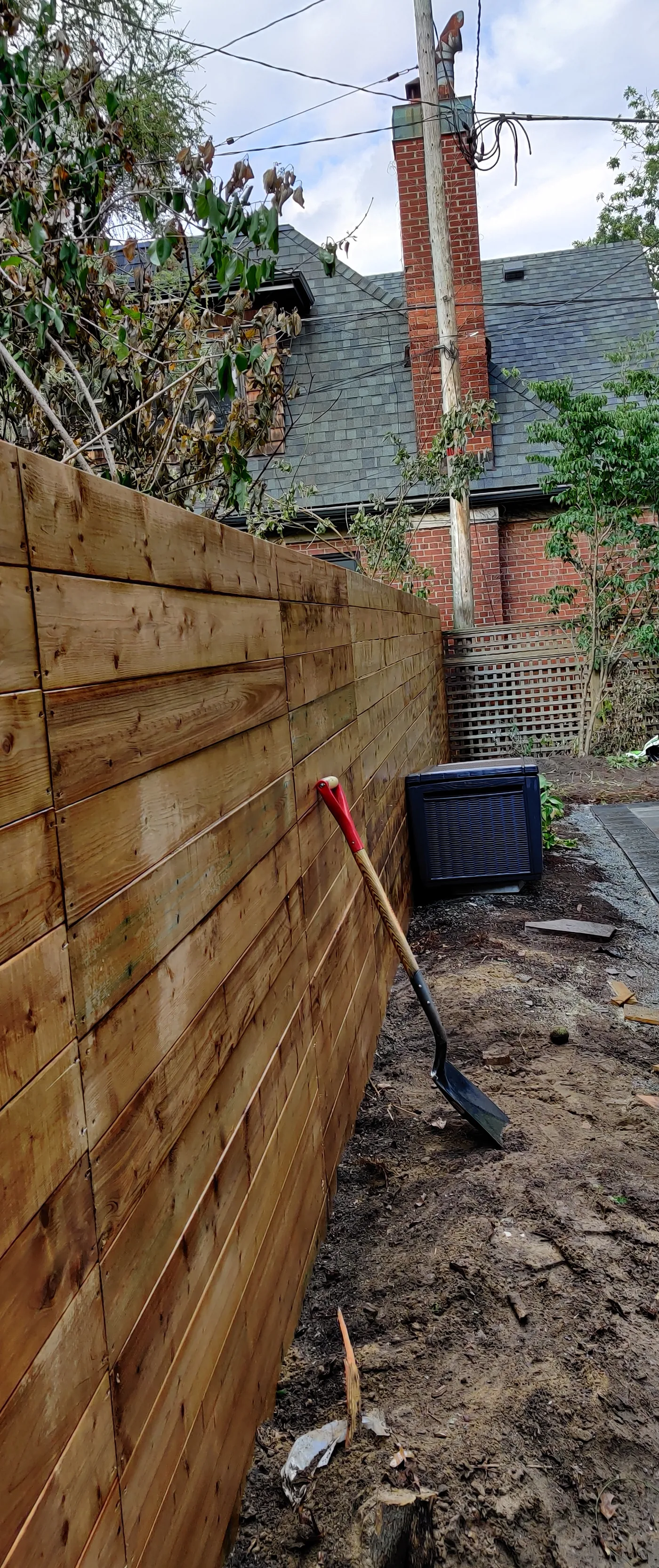 Six foot horizontal board privacy fence in pressure-treated wood in East York