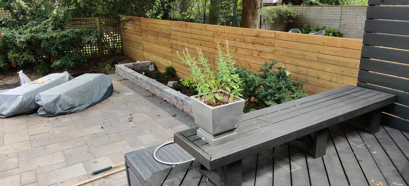 Patio, raised planting bed and bench along the new privacy fence in East York