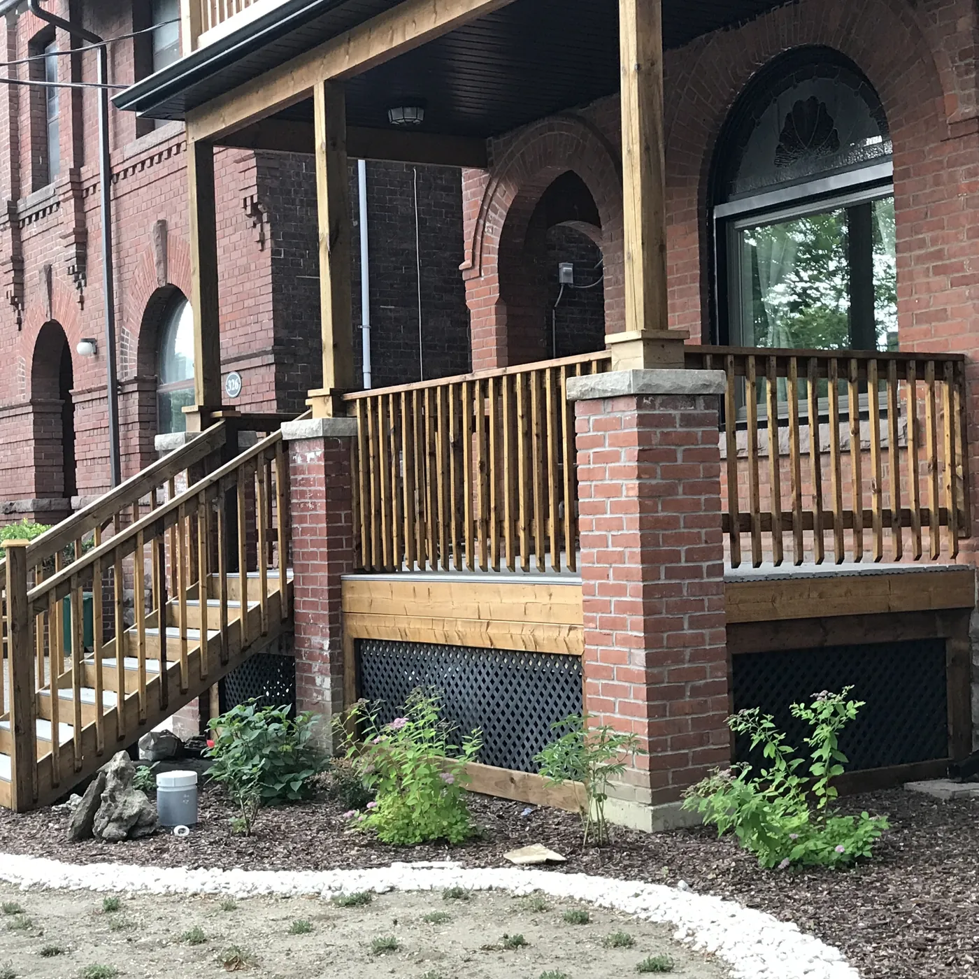 Lower porch deck built between the original brick columns, Etobicoke
