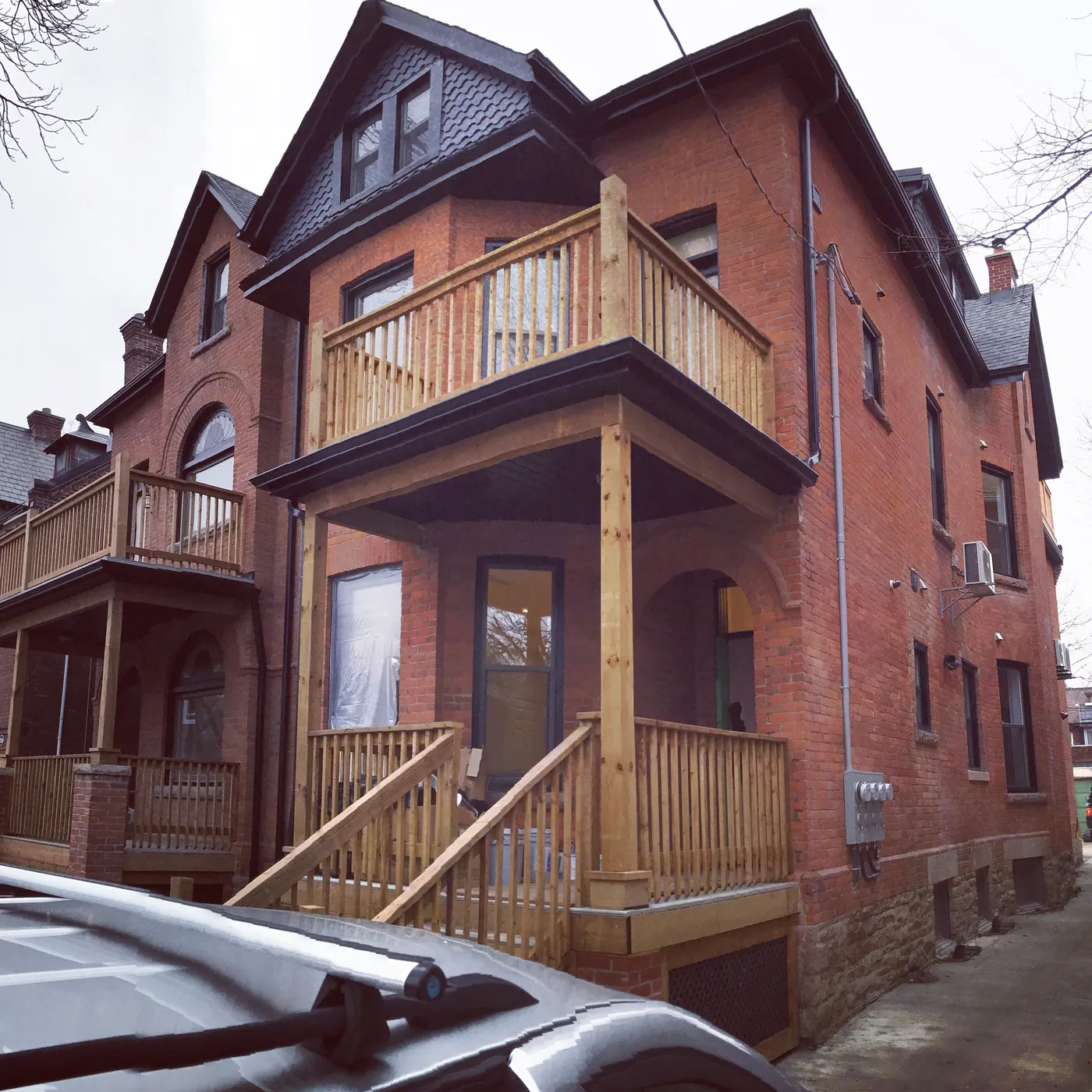 Both units seen from the drive with new porches at two levels, Etobicoke