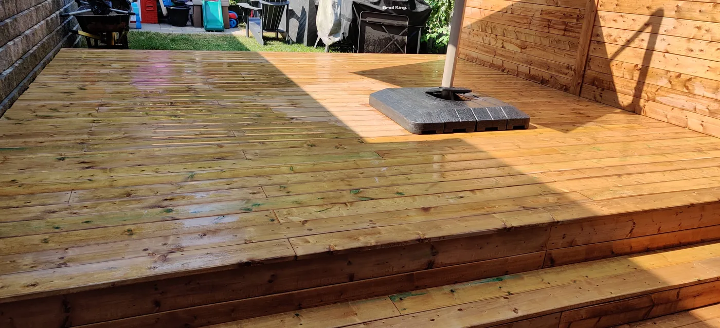Pressure-treated deck boards and the full width step down to the lawn in King City