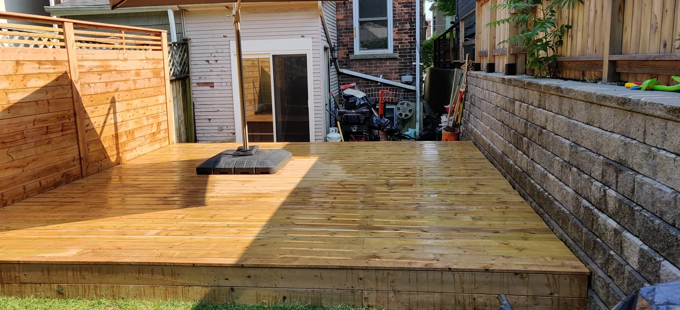 The finished King City deck looking back from the house door past the stone retaining wall