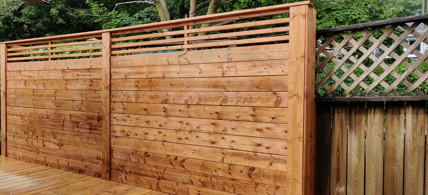 New horizontal fence boards meeting the old lattice panel fence in King City