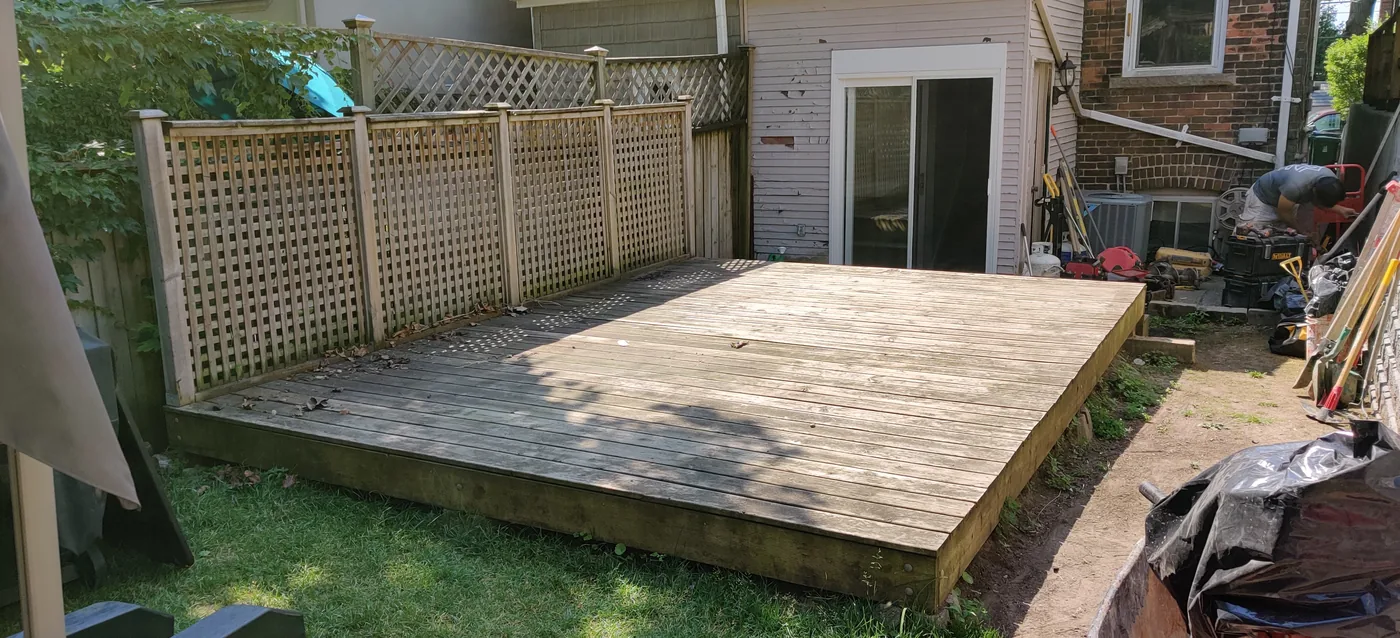 The old grey deck and lattice fence in the King City backyard before the rebuild