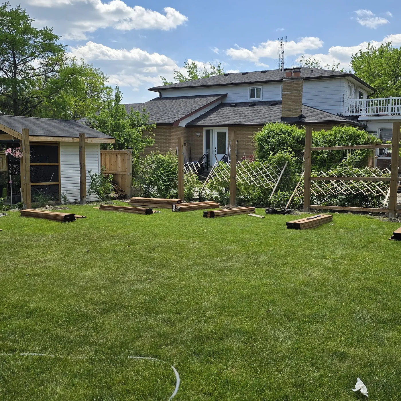 New posts set along the back of the yard with the old fence sections cleared, Markham