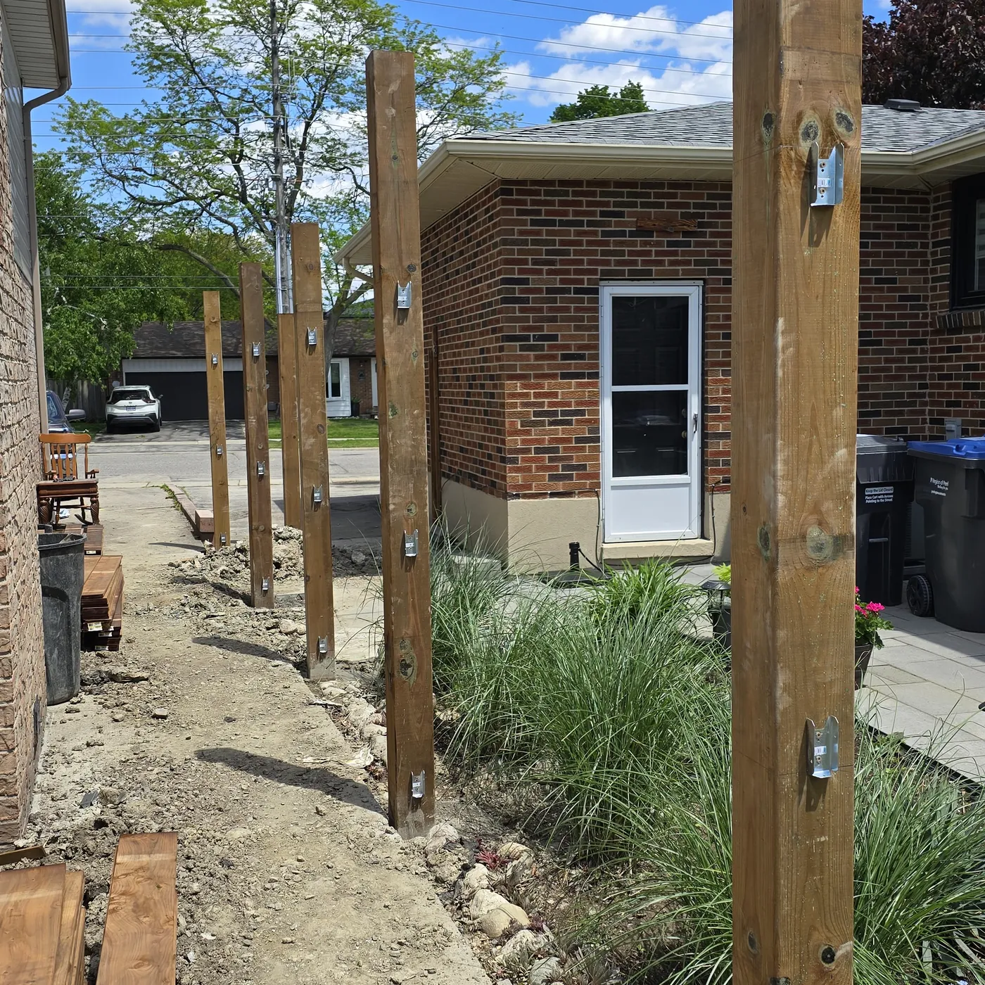 Replacement fence posts plumbed and braced along the property line, Markham