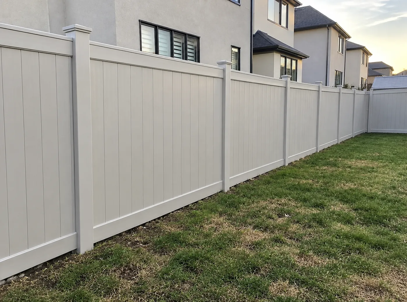 Solid tongue and groove vinyl privacy panels running along the lot line in Milton