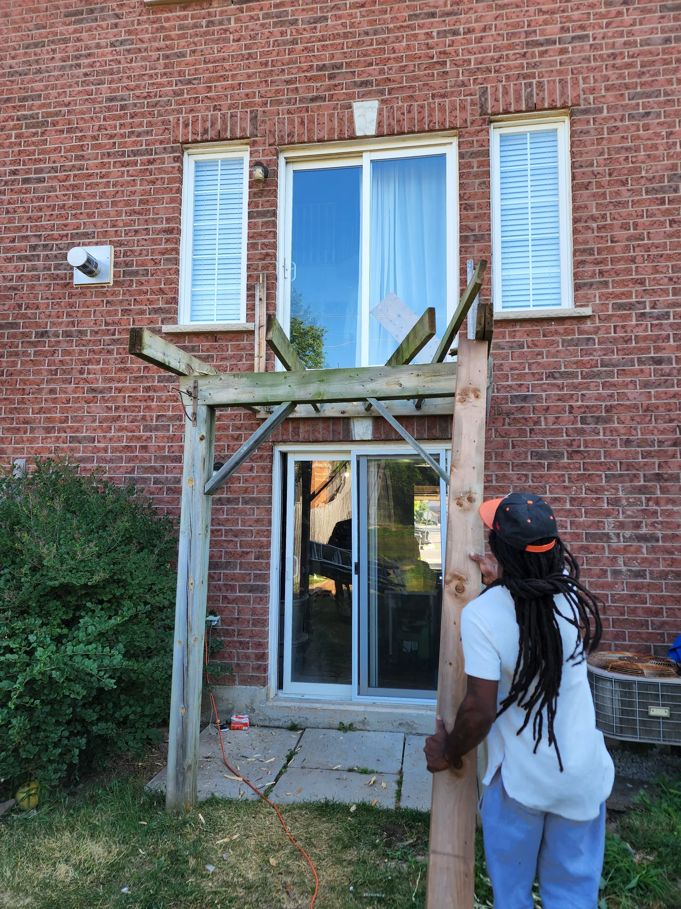 Setting a post against the house at the start of the Mississauga deck build