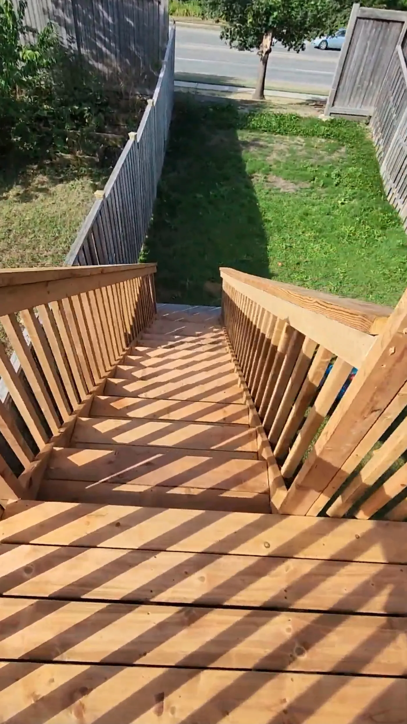 Looking down the deck stairs to the lawn from the second level, Mississauga