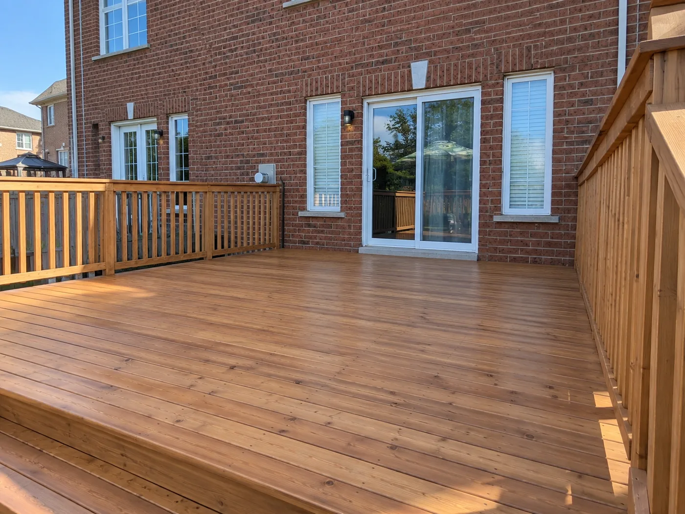 The full width of the Sienna pressure-treated deck outside the rear doors, Mississauga