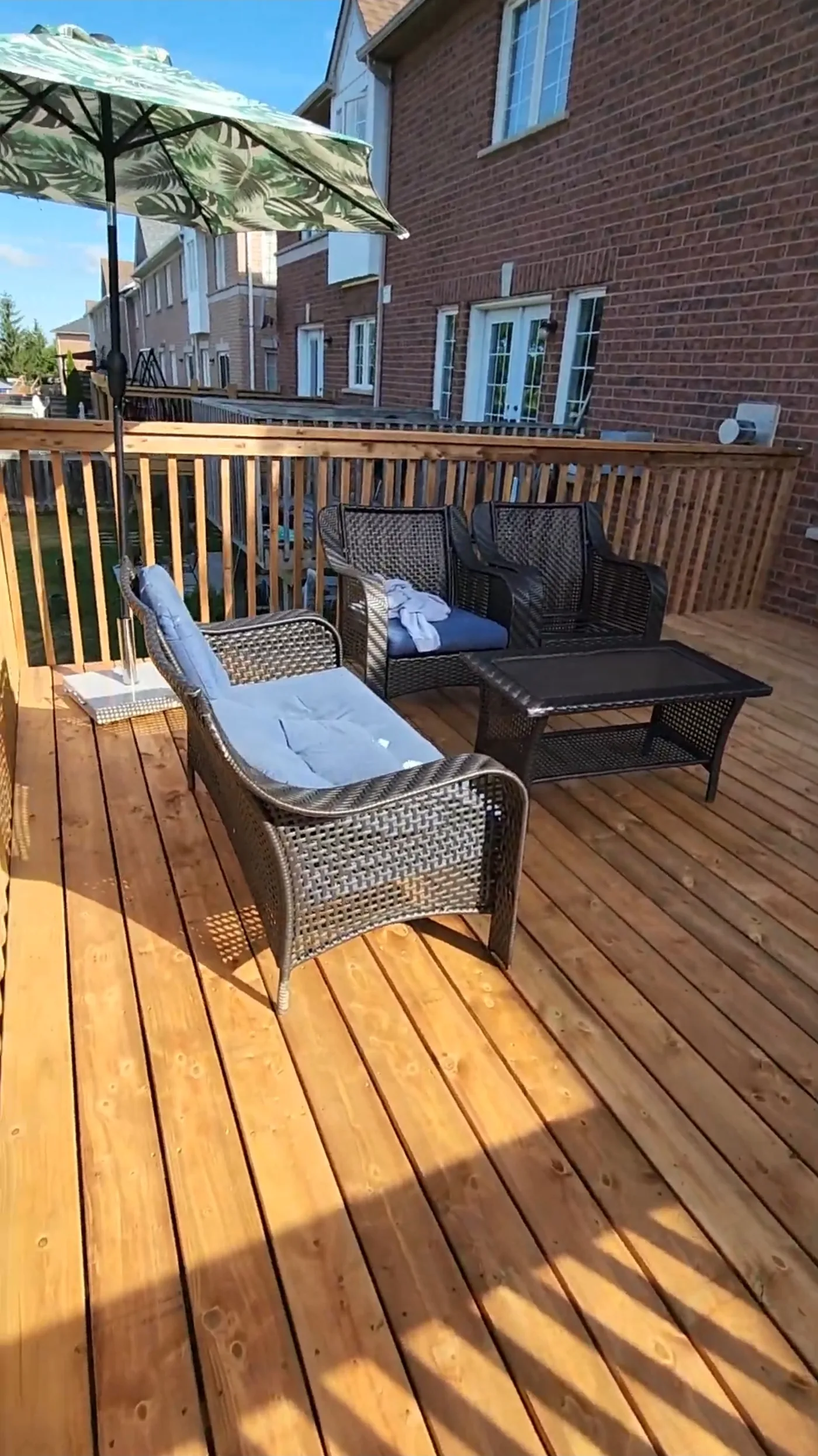 Loungers and an umbrella on the finished second level deck in Mississauga
