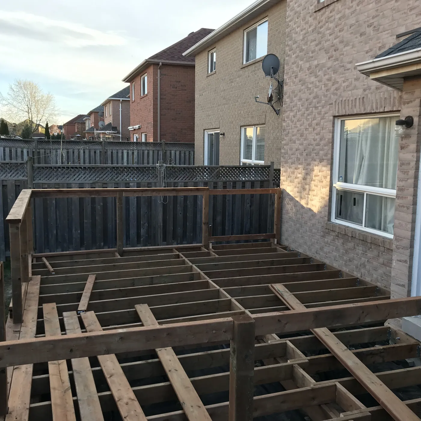 Pressure-treated deck boards going down over the joists, Newmarket