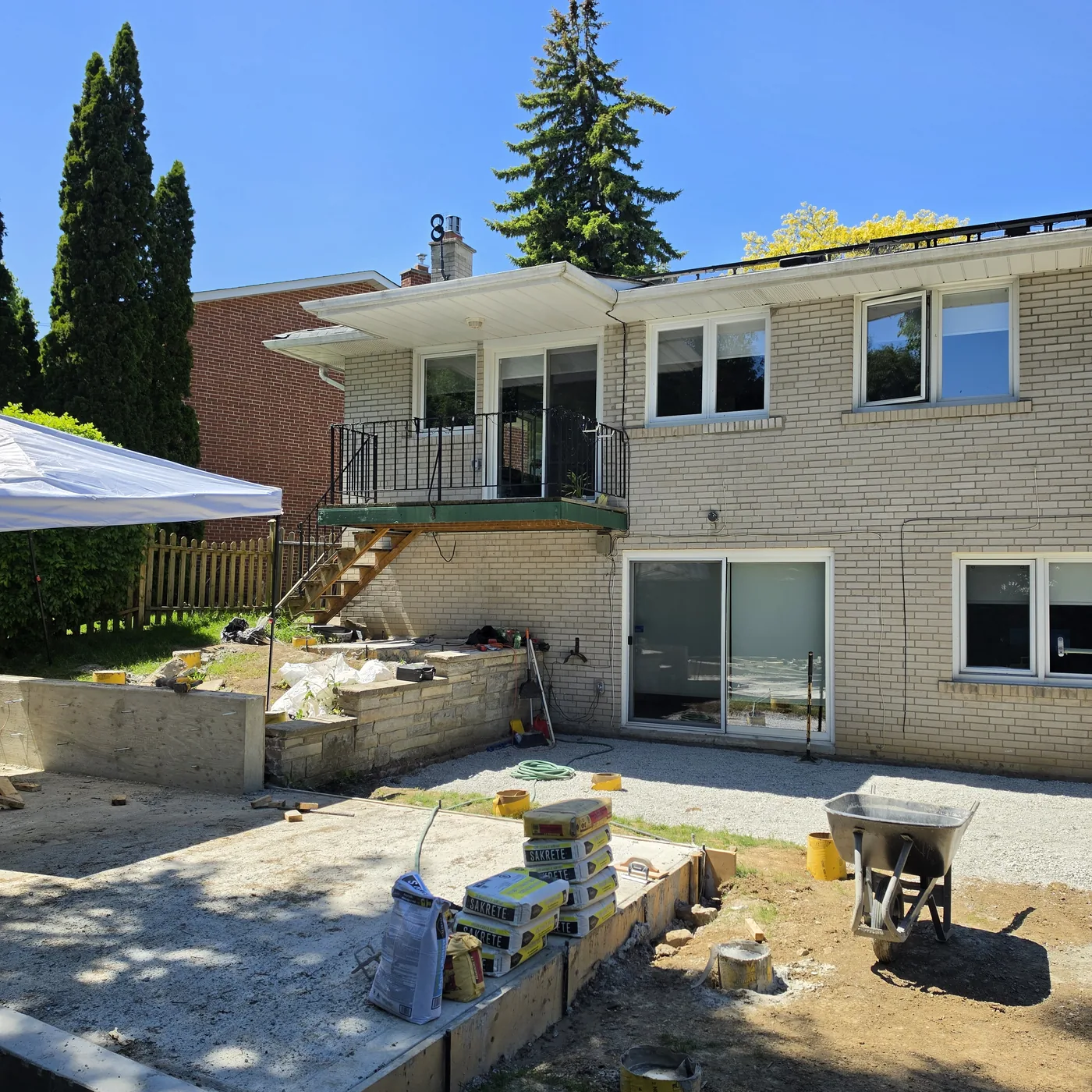 The North York backyard before work started, with an old concrete pad and block retaining wall
