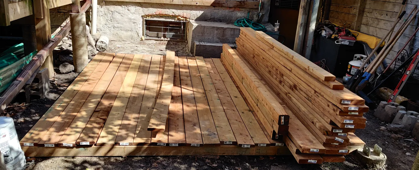 The site cleared after demolition with new lumber stacked ready in North York
