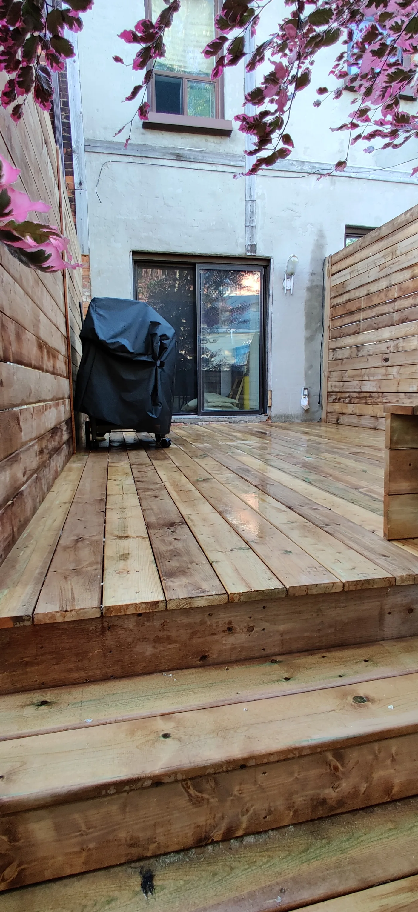 Rebuilt pressure-treated deck outside the rear doors of a North York home