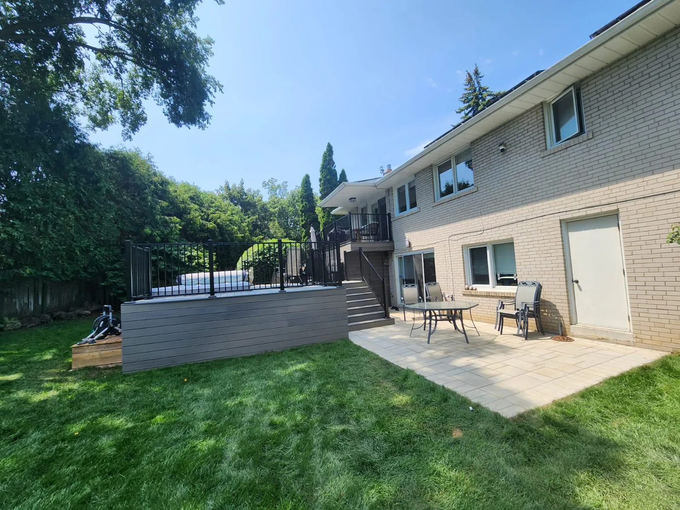 The finished North York backyard with deck, paver patio and new sod