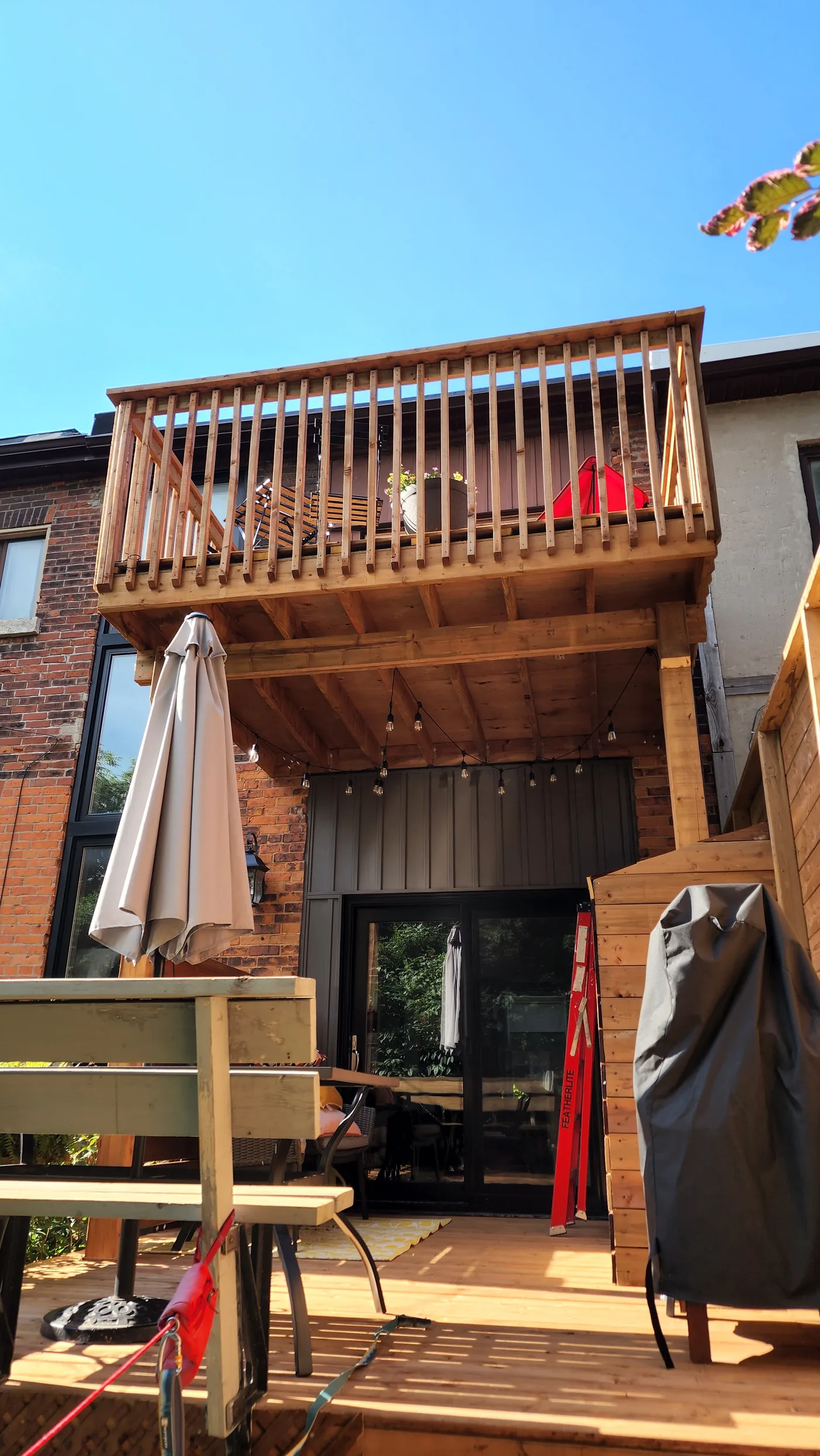 The finished two-level deck with the upper level over the covered lower deck in North York