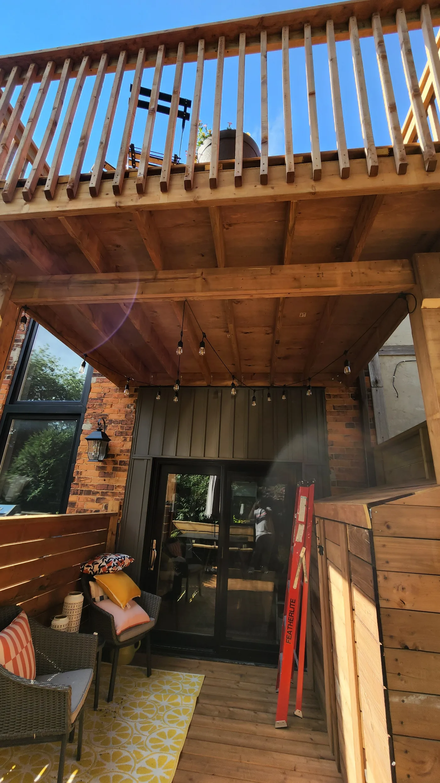 Upper deck and railing seen from the covered lower deck in North York