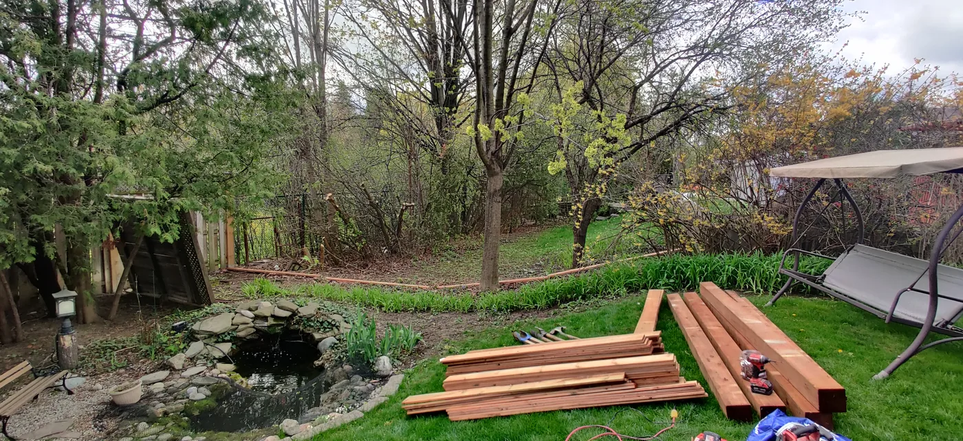 Pressure-treated fence lumber laid out on site in Oakville