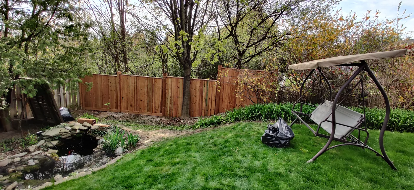 New fence stepping with the grade across a sloped Oakville backyard