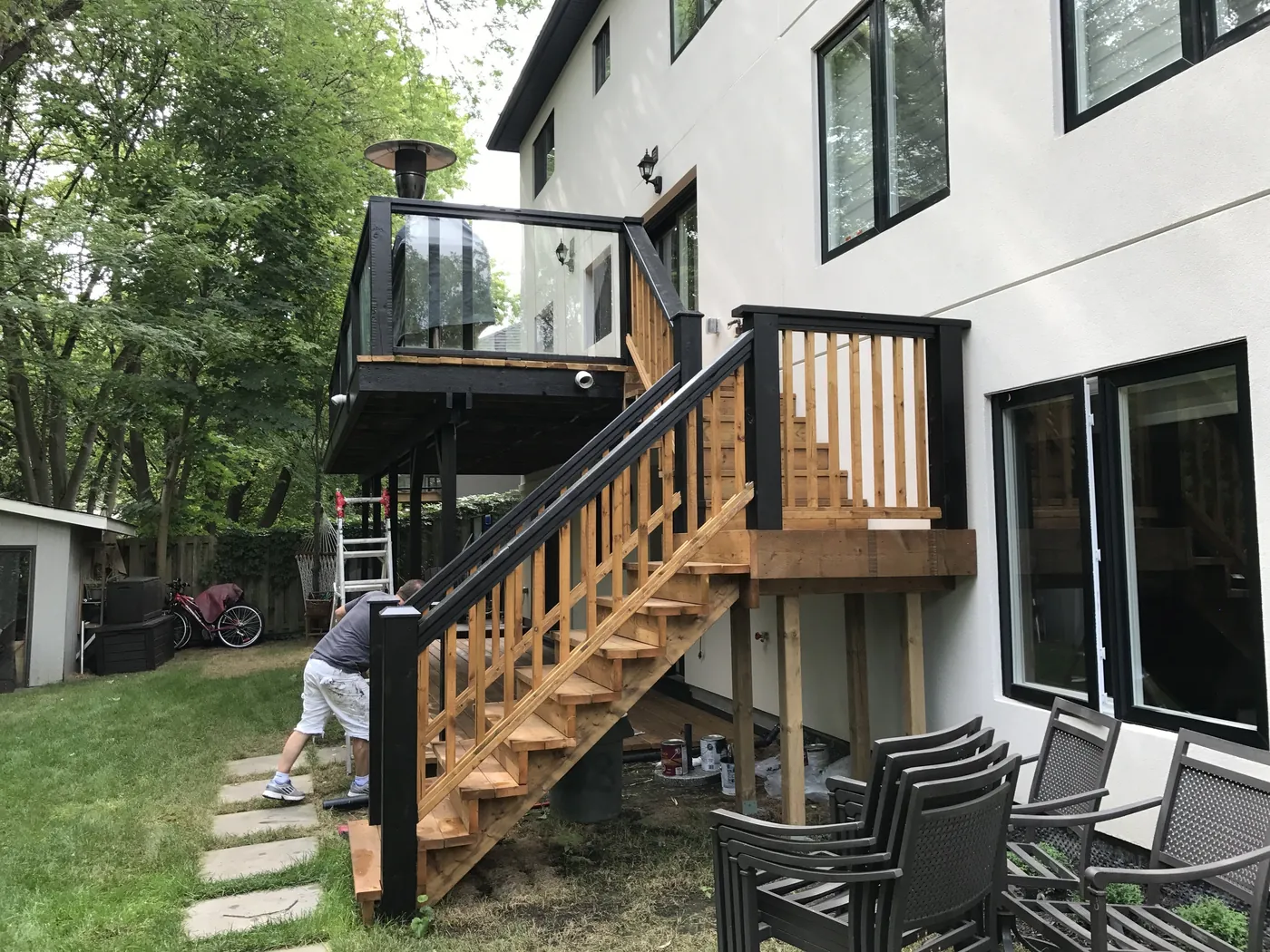 Raised deck with a glass railing and stairs down to the garden, Oakville