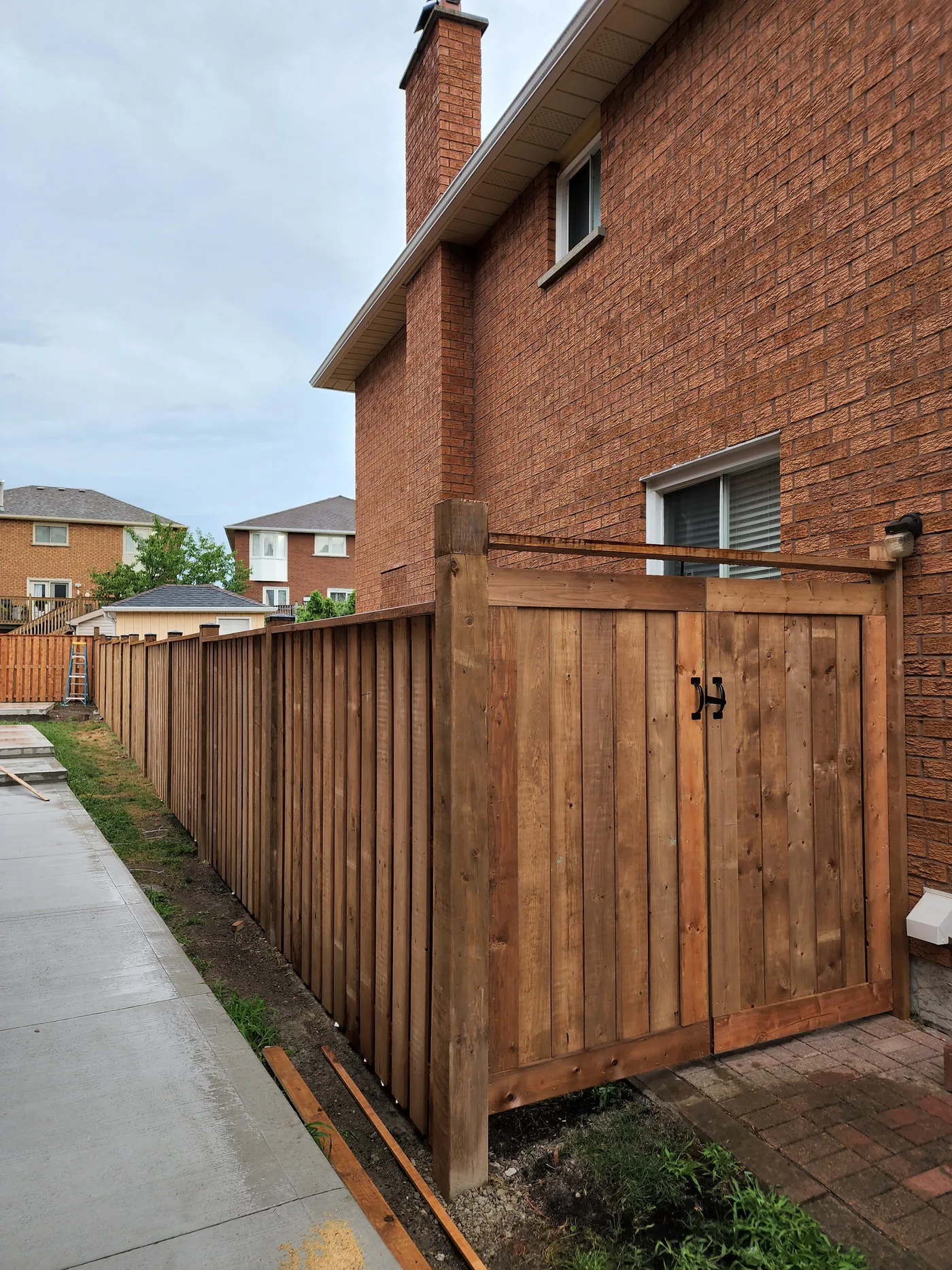 New gate in the side yard fence run in Richmond Hill