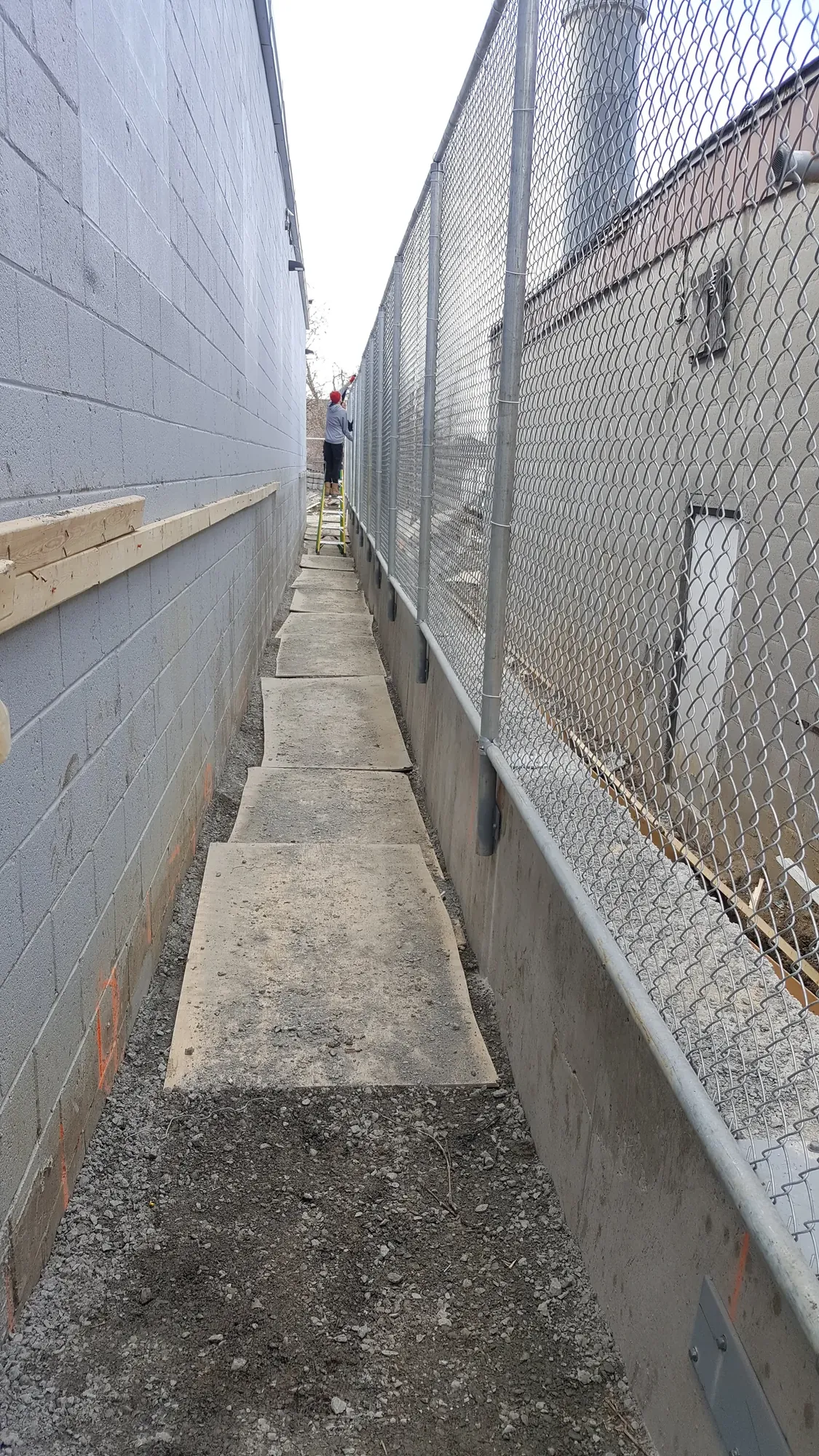 Commercial chain link fence line running the length of the gap at a Scarborough warehouse