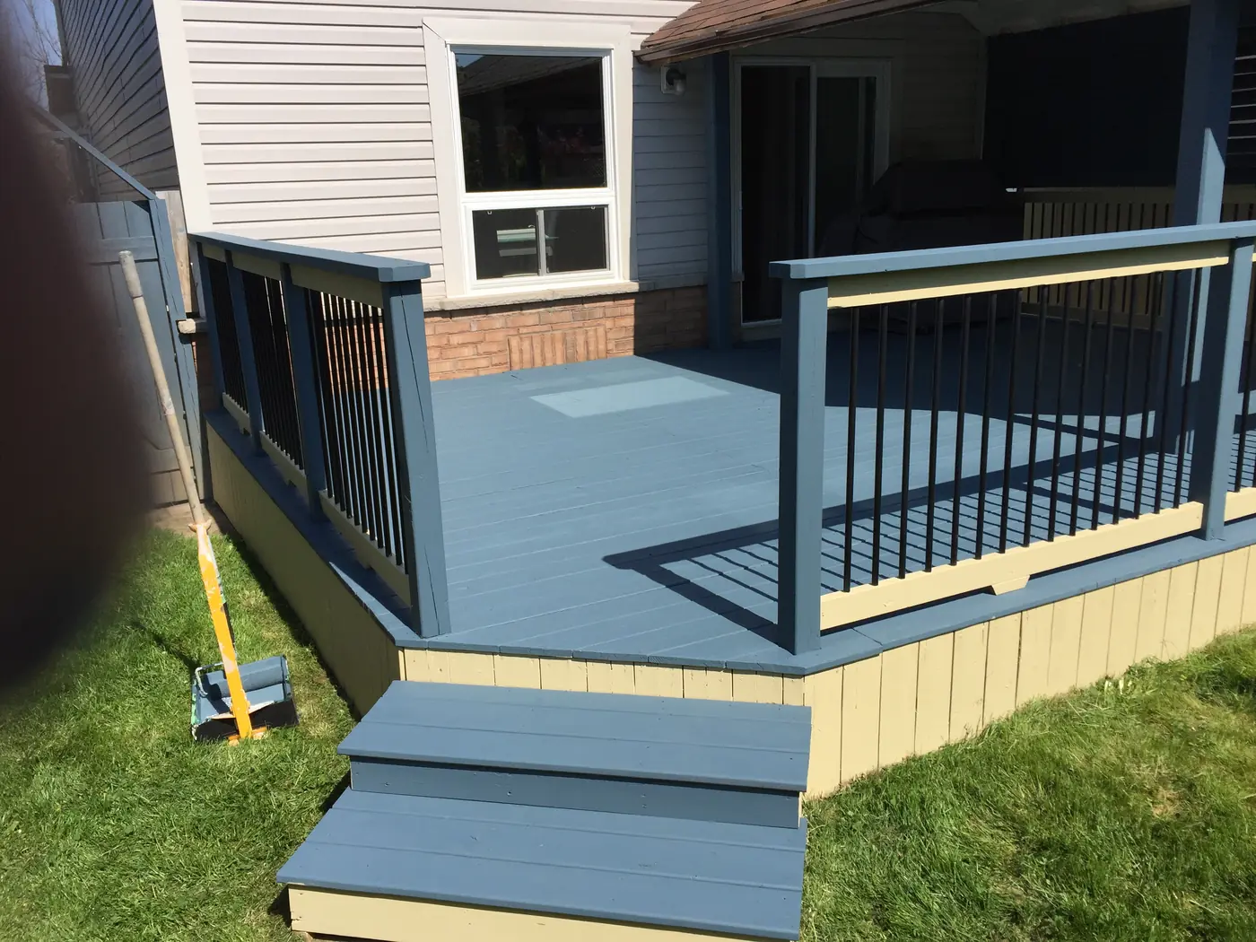 Repainted deck with new railings and black pickets after repair, Stouffville