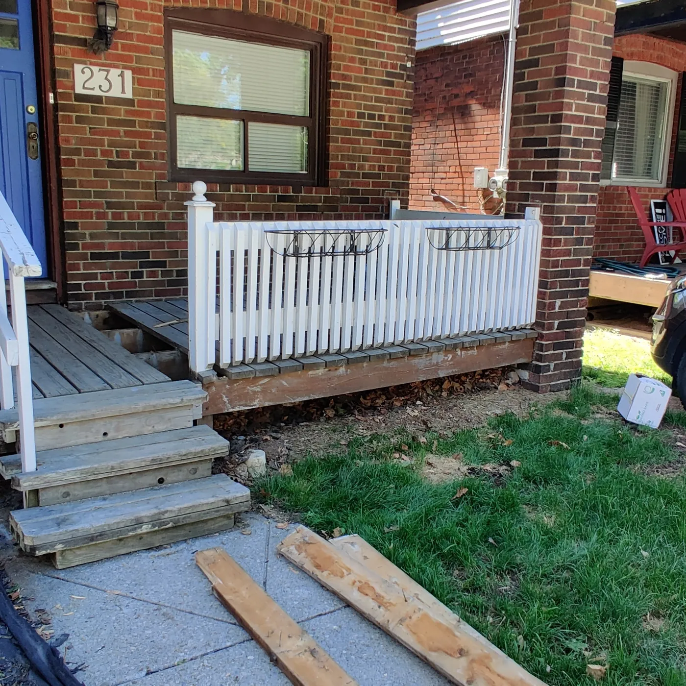 Worn porch boards and vinyl picket railing at the start of the job, Toronto