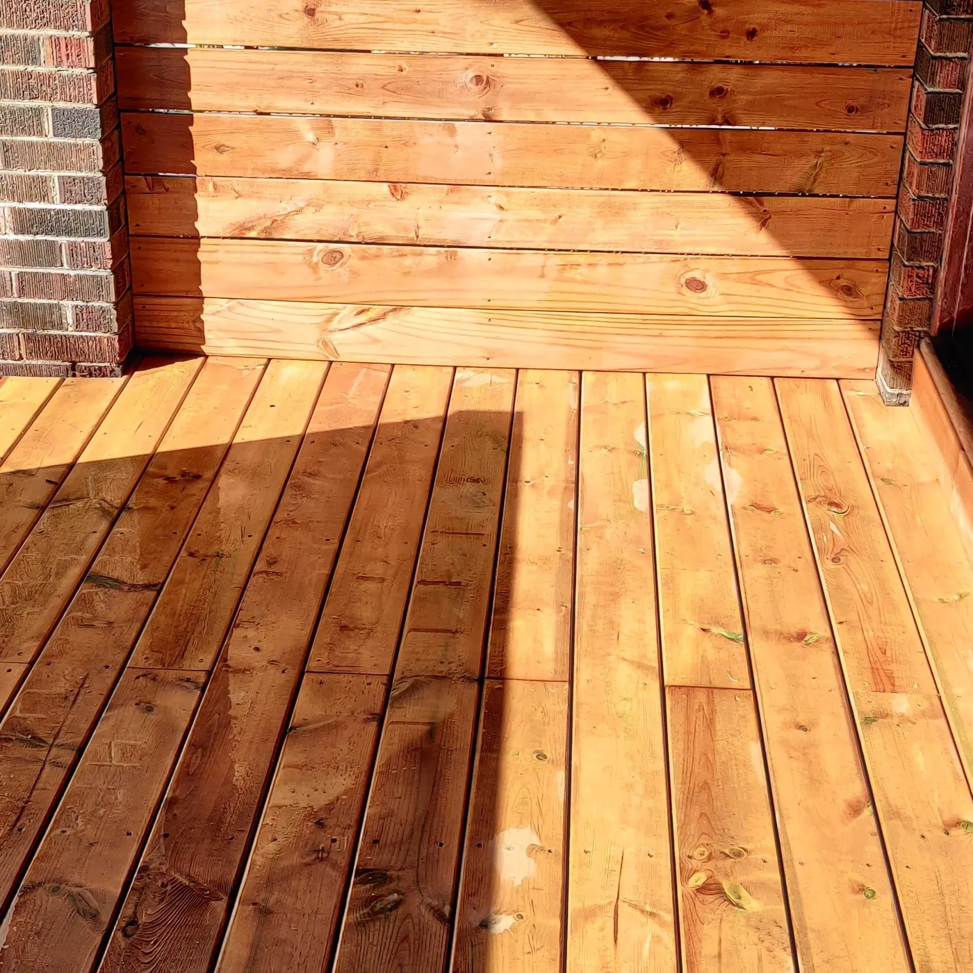 Cedar deck boards running across the finished front porch, Toronto