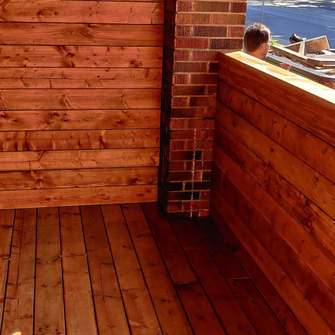 Corner of the cedar privacy screen where it meets the brick pier, Toronto