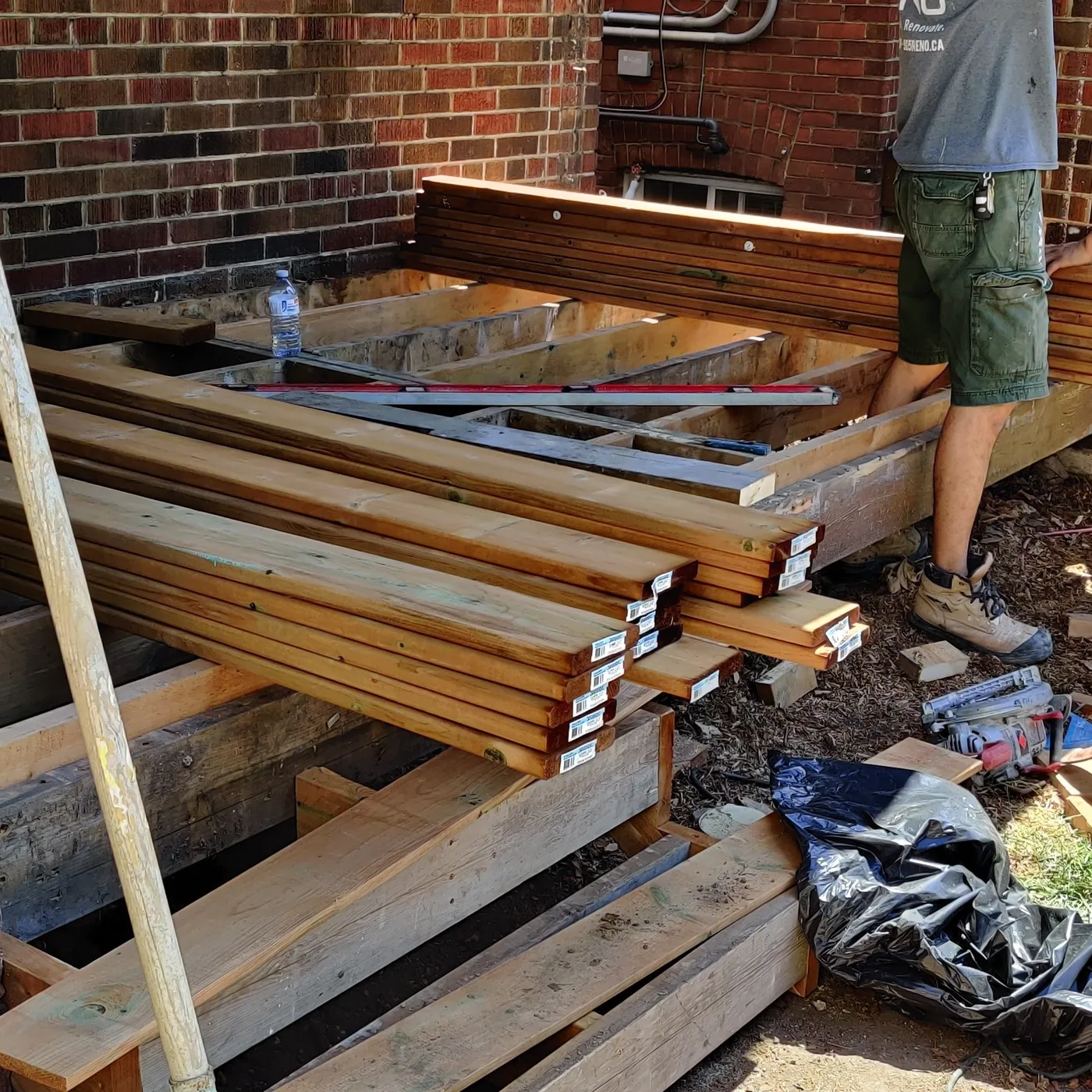 New pressure-treated frame going in across the porch, Toronto
