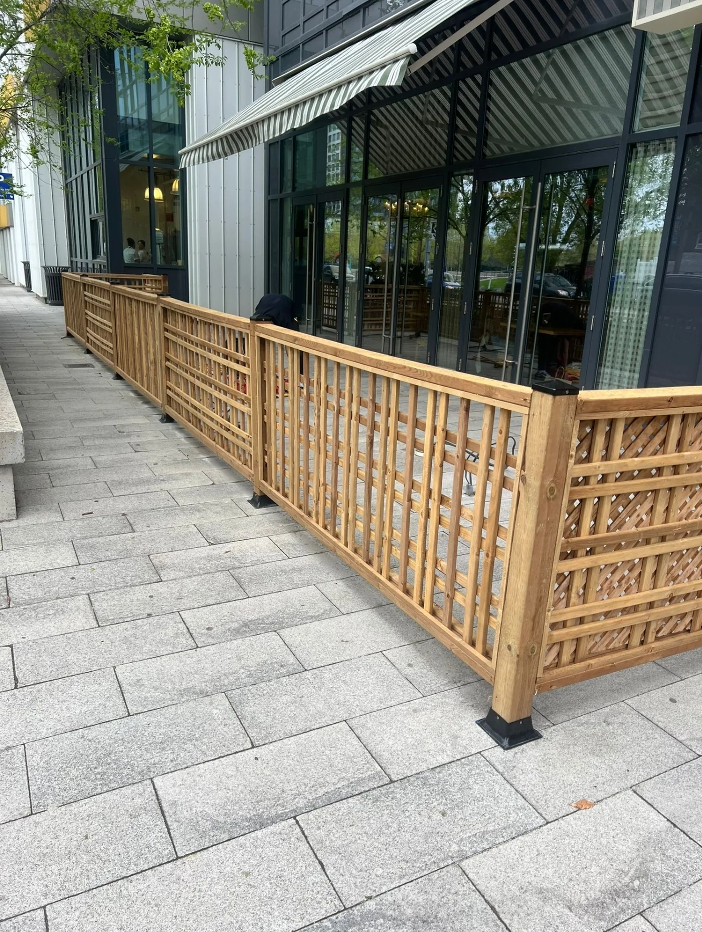Lattice patio screen running along the glass frontage of a Toronto restaurant