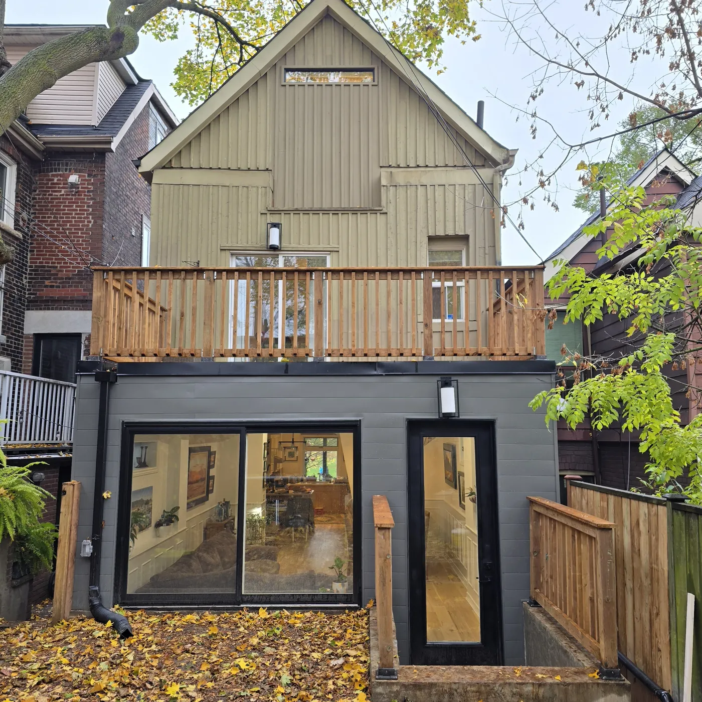 The rear elevation with the roof deck above the extension and its sliding doors, Toronto