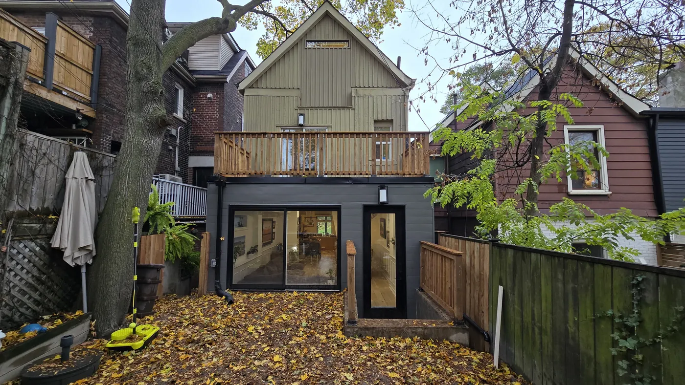 Roof deck with a cedar railing on top of a rear extension, Toronto