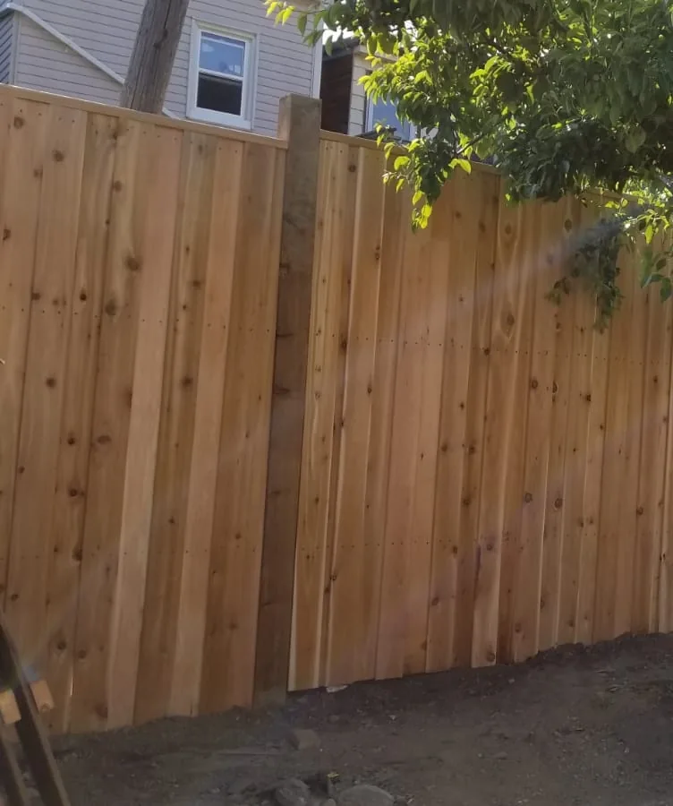 Vertical cedar boards butted tight along the new fence line in Vaughan