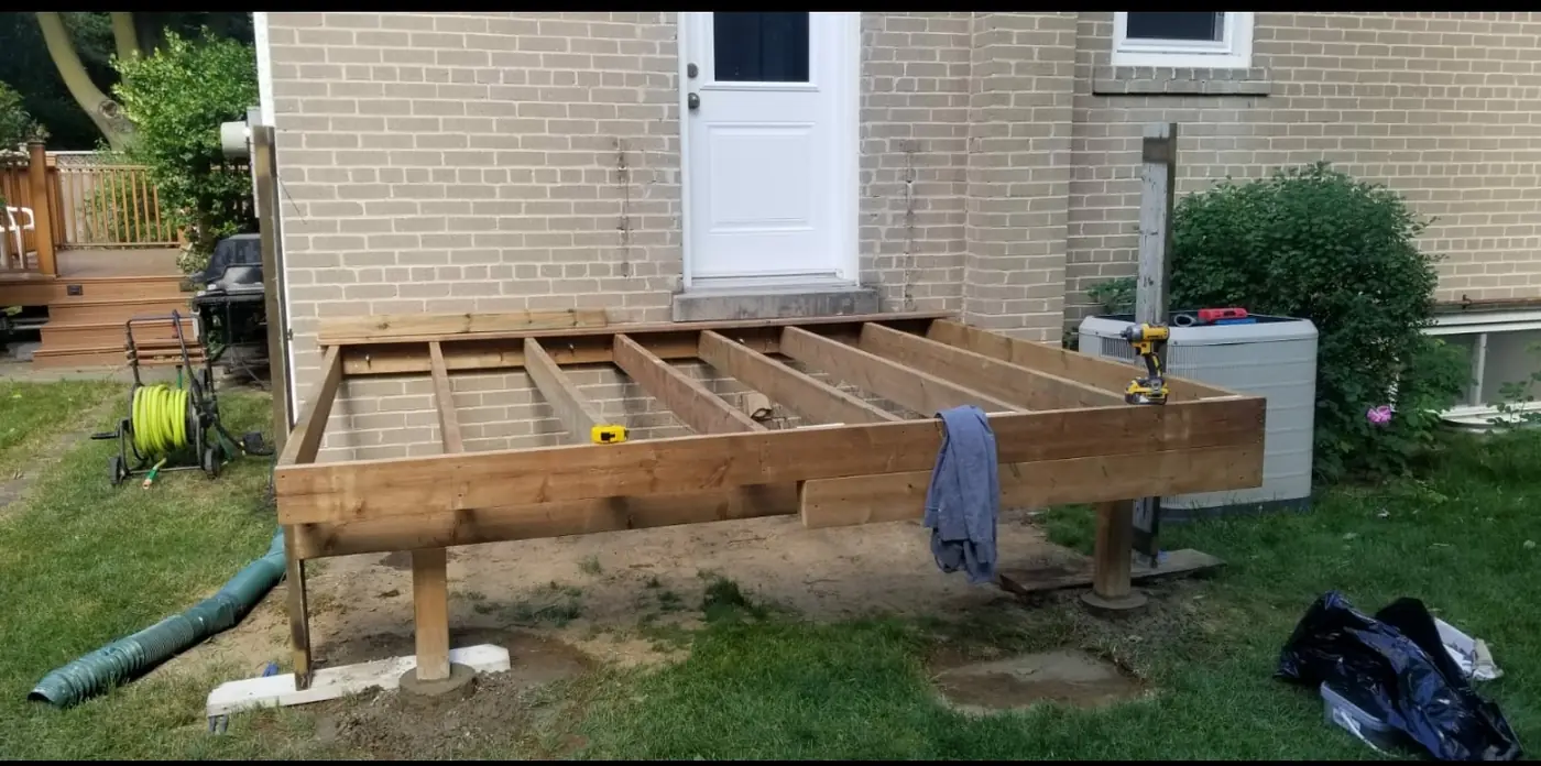 New deck framing on pressure-treated posts set on concrete footings, Whitby