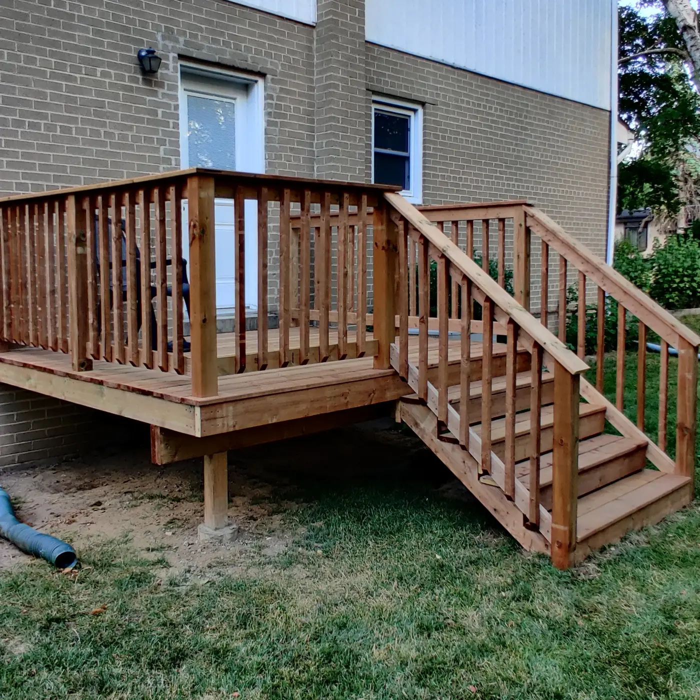 The full rebuilt deck and stairs at the side entrance seen from the lawn, Whitby