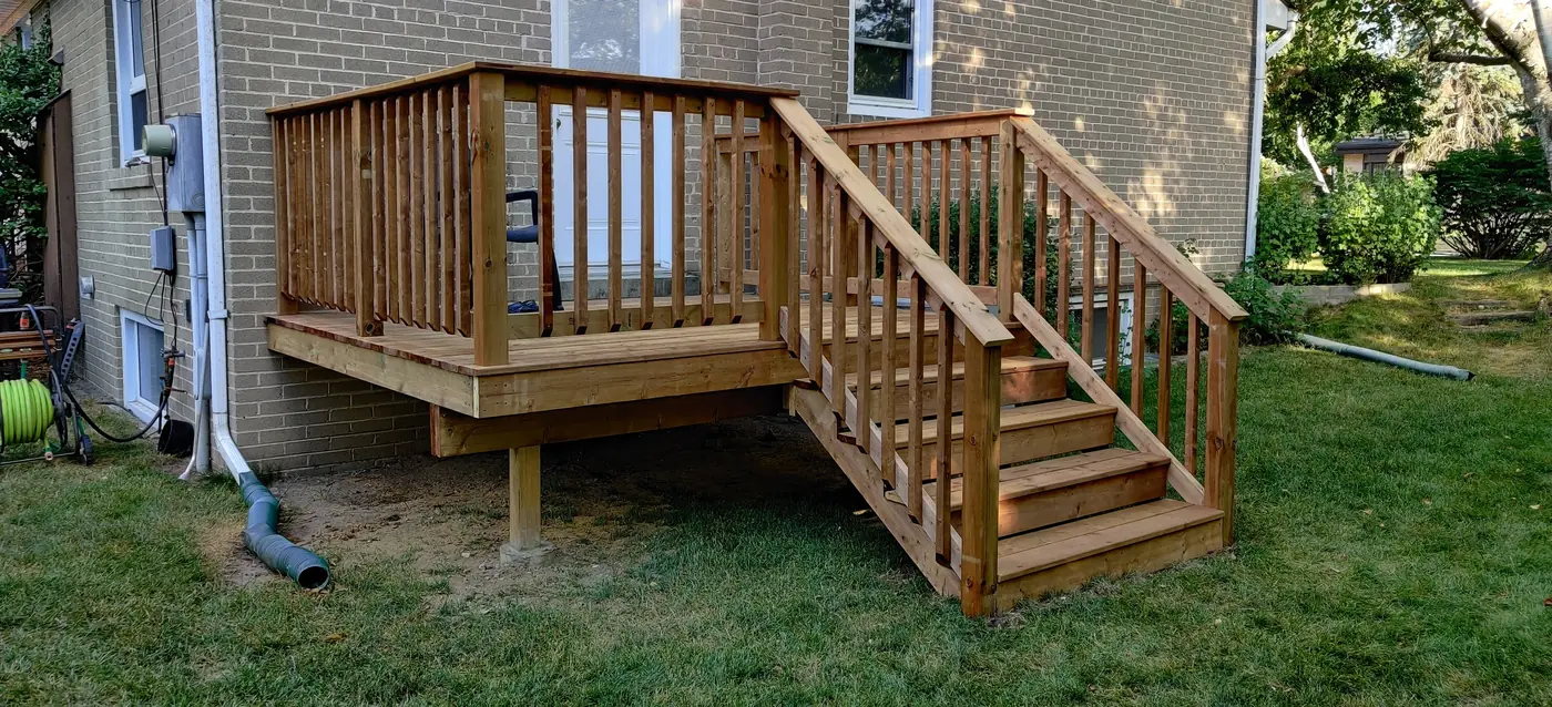 Rebuilt pressure-treated deck and stairs at a side entrance, Whitby